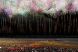 Grand finale fireworks lighting up the night sky above a crowd of spectators at a Japanese fireworks festival, fine art photograph by Mitsuki