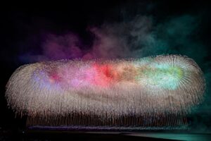 Multicolored low-burst fireworks forming a ring of light and smoke at a Japanese festival, fine art photograph by Mitsuki